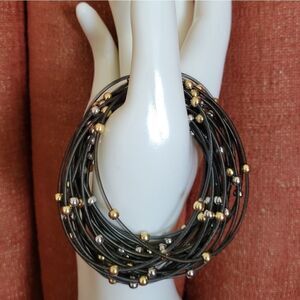 Set of 24 Spring Bracelets with gold and silver beads.